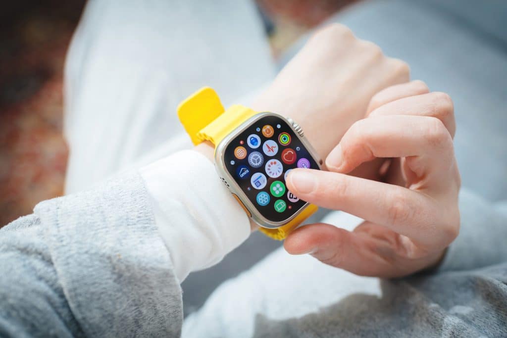 Smartwatch Apple Watch 8 z żółtym paskiem na nadgarstku