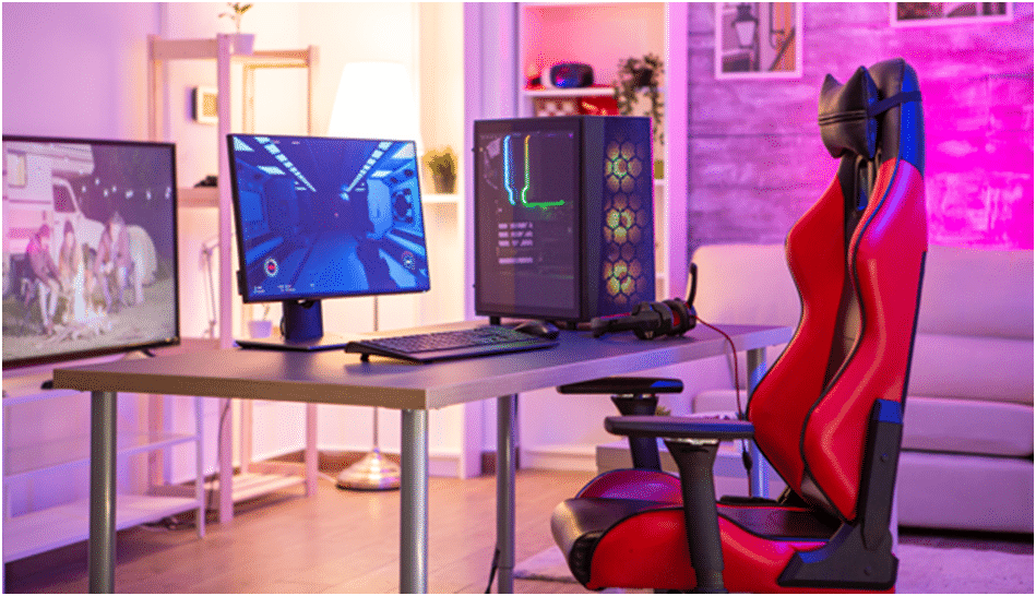Pokój gracza z fotelem gamingowym, biurkiem, monitorem, telewizorem i komputerem pc